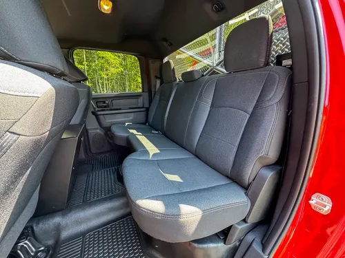 Rear cabin interior from opposite side showing bench seat and front seat backs.